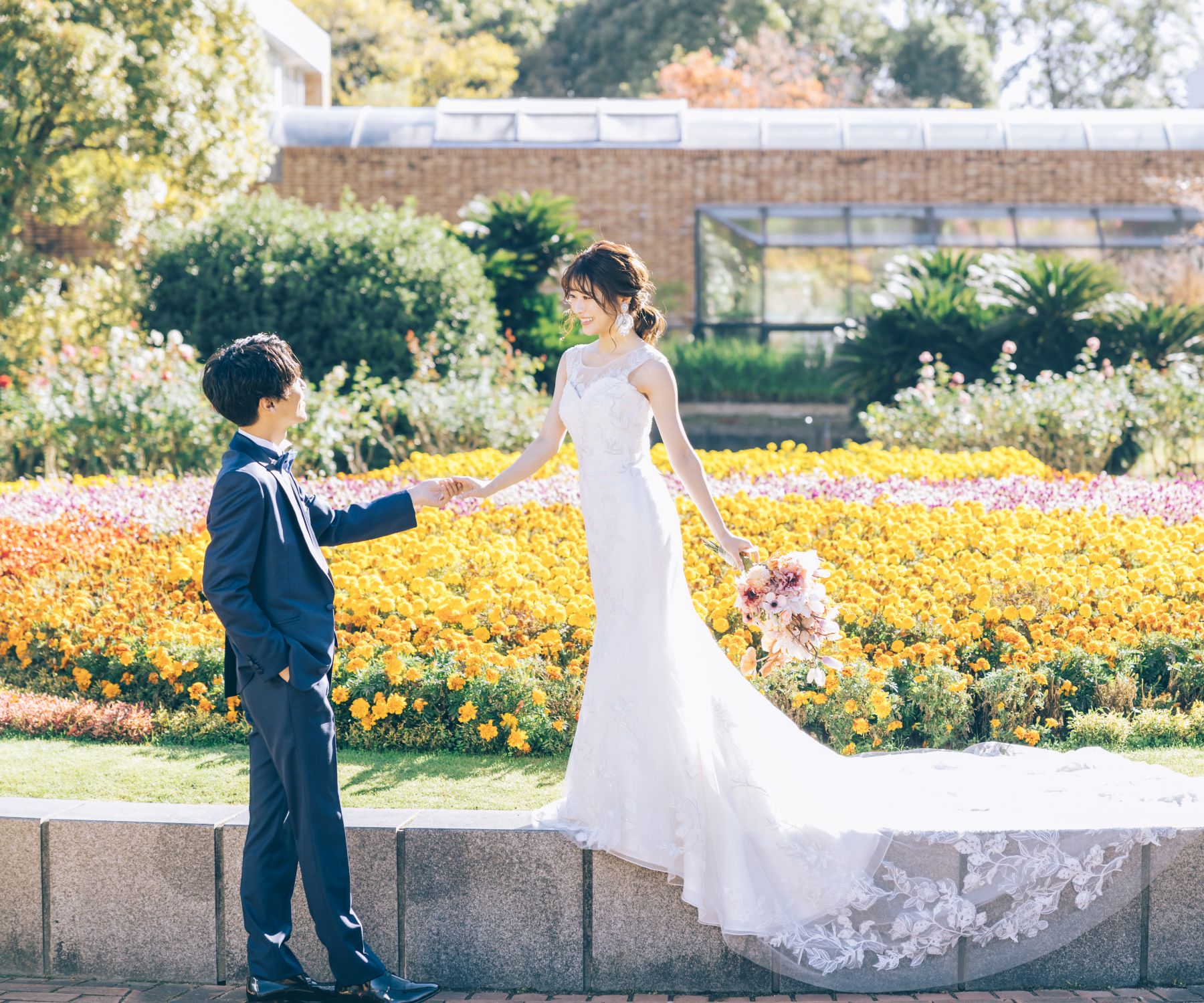 見つめ合いながら新婦様の手を取る新郎様のウェディングフォト