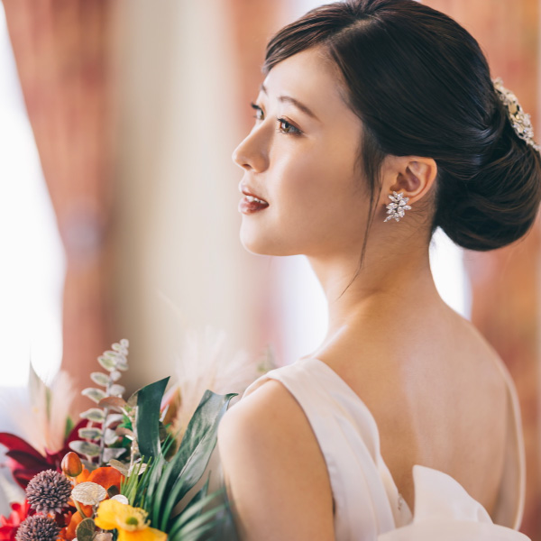 花束を抱えて遠くを見つめる新婦様のソロショット