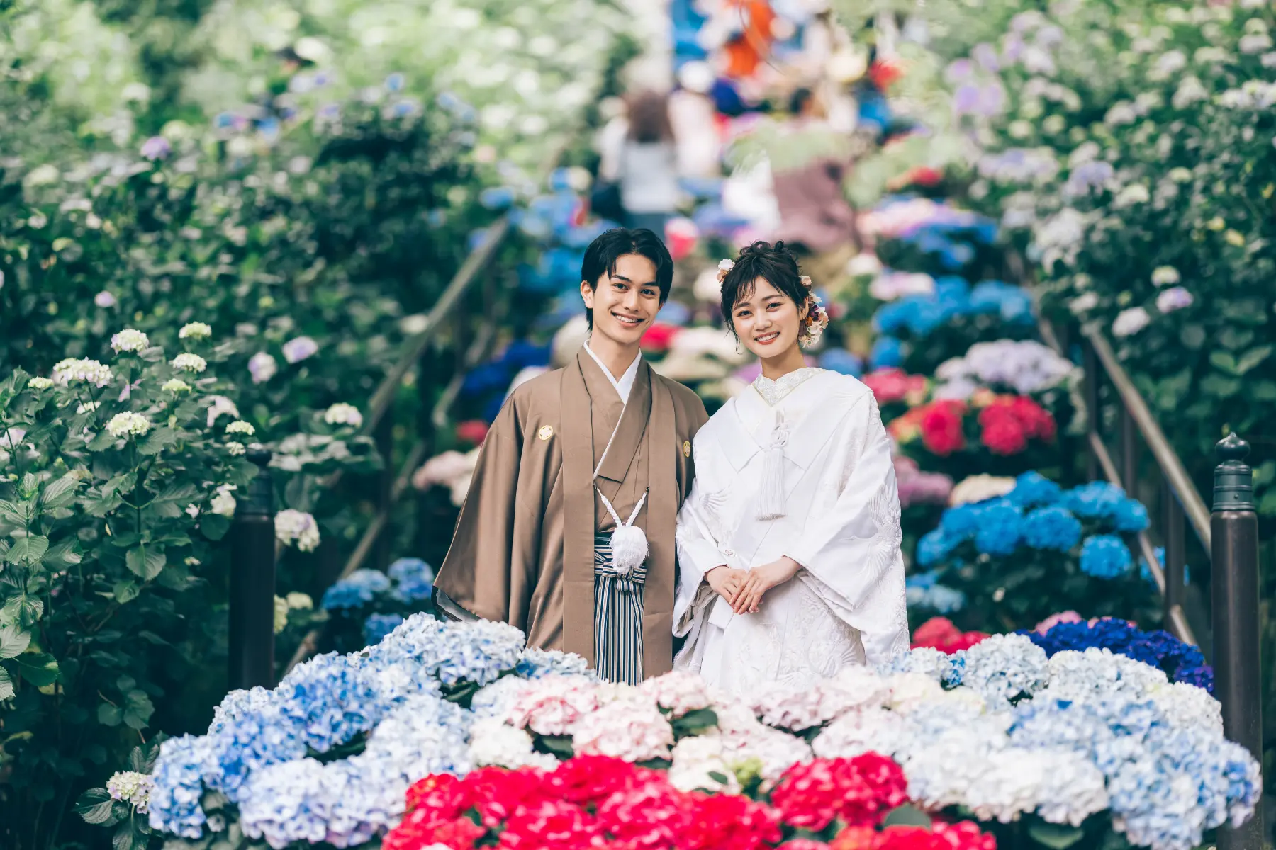 新緑の中で新婦様を抱き上げる新郎様のロケーションフォト