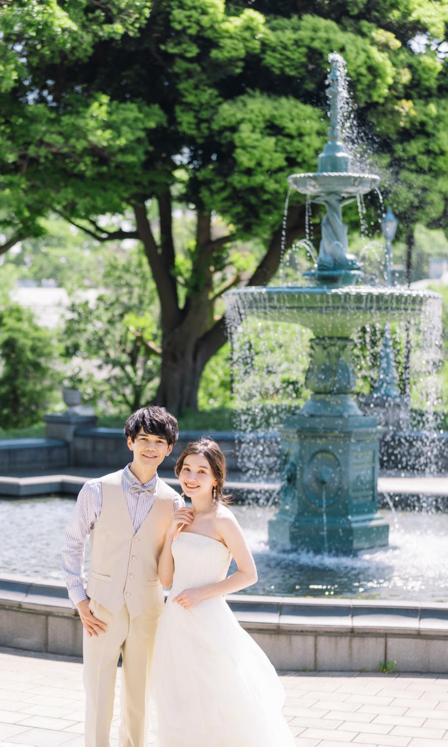 噴水の前で撮影する新郎新婦様のウェディングフォト