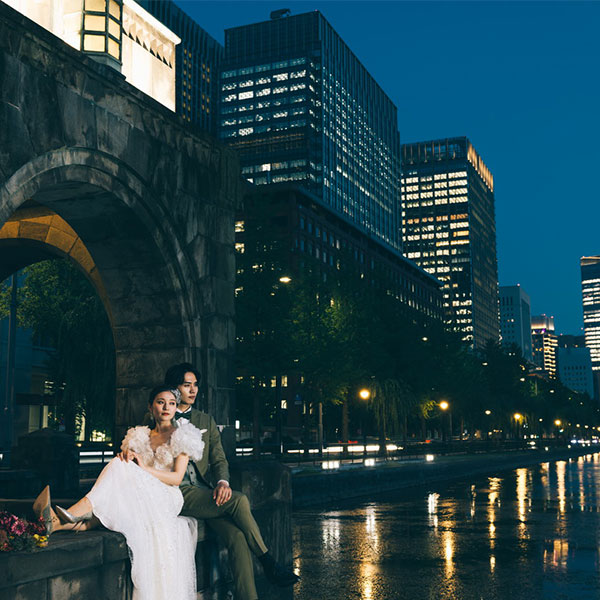 東京駅舎の前で抱き合う新郎新婦様のウェディングフォト