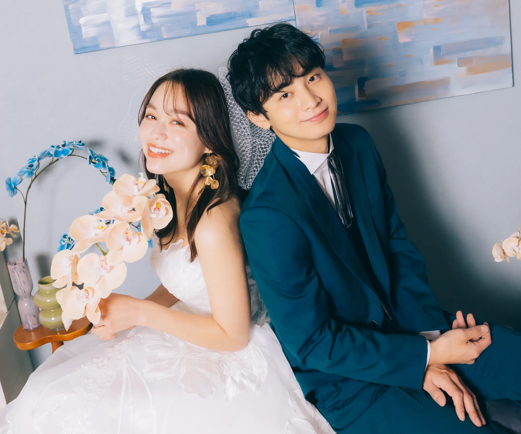 ポーズを撮る新郎様と腕を組むブーケを持った新婦様のウェディングフォト                    